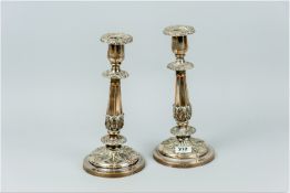 A pair of circular based leaf pattern Sheffield plated candleholders with segmented and tapered