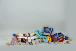 A very large and interesting parcel of Masonic regalia, aprons, sashes and badges etc, many