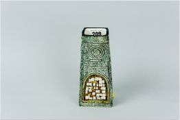 A Troika coffin shaped vase having an all over granite type pattern incised with various Aztec style