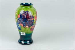 A Moorcroft 'Clematis' good size vase of waisted form, green ground body tapering to a blue ground
