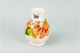 A Moorcroft 'Hibiscus' pattern cream ground vase, 5.5 ins (14 cms) high