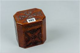 A 20th Century hexagonal tea caddy with carved top and front and side panels, the lid opening to