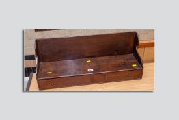 An oak two drawer desktop bookstand having shaped side panels and full wooden back, oak lined