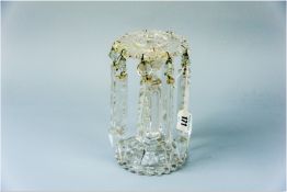 An uncoloured glass circular based drop lustre candleholder, 8 ins (20 cms) high with faceted and