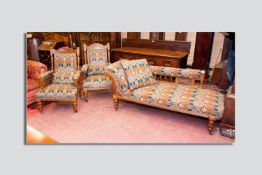 An excellent carved oak drawing room suite of two armchairs and chaise longue, well carved