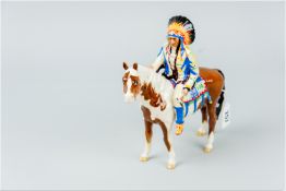 A Beswick Indian Chief on horseback, the Chief in brightly coloured clothing and headgear, seated