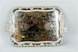 An oblong twin handled electroplated tray having a vine leaf border and with bright cut scrolled