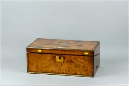 A Victorian walnut and brass bound writing slope having a figured walnut top with brass plate