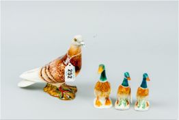 A Beswick pottery model of a pigeon, impressed no. 1383, 5.75 x 7 ins (12.5 x 18 cms) along with a