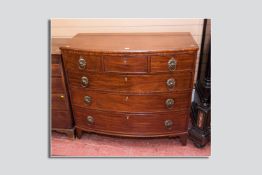 A Victorian mahogany bow front chest of drawers with heavy brass ring handles, 44 ins (113 cms) wide