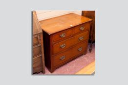 A light oak two over two chest of drawers with brass back plate swing handles, 36 ins (92 cms) wide