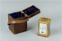 A circa 1900 brass carriage clock with faceted glass panels and swing brass carrying handle along