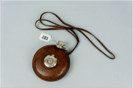 A moon shaped Gucci leather bound hip flask and neck cord