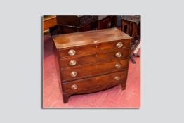 A Georgian mahogany boxwood line inlaid chest of drawers, four graduated drawers having cock bead