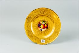 A Royal Worcester gilt relief patterned cabinet plate with central hand painted panel of fruit by