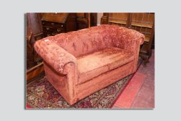 A good quality button upholstered Chesterfield settee in a rich rust leaf decorated upholstery