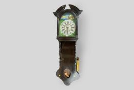 An oak encased late 19th Century Dutch alarm timepiece, the arched painted dial having Roman