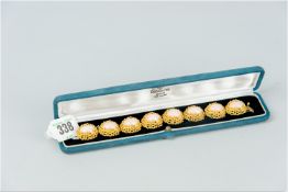 A fine angel skin coral bracelet, each of the eight oval cabochon corals enclosed in an eighteen