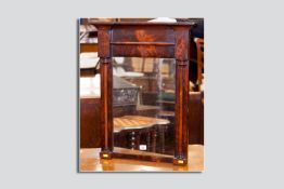 A Georgian flame mahogany wall mirror in the architectural style, an inverted frieze on block