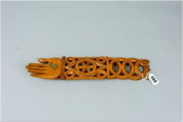 A carved wooden lovespoon of pierced intertwined circles, a diamond centre panel with floral