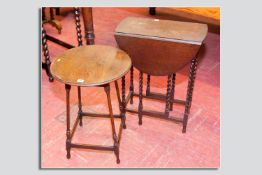 An oak circular topped spindle legged table and an oak barley twist gate leg table with end drawer