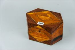 An early 20th Century inlaid tea caddy, the top multi inlaid with rosewood, yew wood and boxwood etc