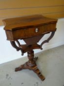 A Victorian mahogany sewing table, raised on a carved tripod-base, the hinged lid revealing an