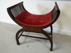 An inlaid mahogany x-stool of ribbed form with button upholstery to the seat