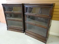 A pair of dark wood Globe-Wernicke four tier glazed bookcases 34 ins (87 cms)
