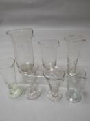 Seven nineteenth century and early twentieth century glass pharmacy measures