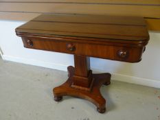 A mahogany fold-over tea-table with column support on a shaped base, 35.5 ins wide (90 cms)