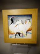 A Moorcroft pottery framed tile 'Snow Ballerinas', 8 x 8 ins (20 x 20 cms)