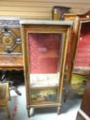 A reproduction vitrine cabinet with single glazed door and painted panel of two courting figures,