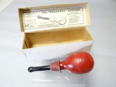 A boxed Braspray syringe