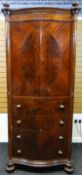 A late nineteenth century mahogany press-cupboard by Maple & Co, of serpentine-form with four