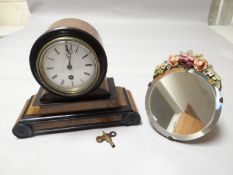 A walnut and ebony drum mantle clock together with a small floral barbola easel mirror