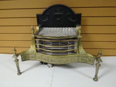 A good brass and iron fire basket of shaped form, decorative frieze and arched back, 30 ins wide (76
