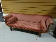 A nineteenth century inlaid mahogany Regency-style day-bed with scrolled ends and on turned