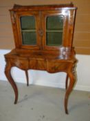 A fine quality nineteenth century cross-banded walnut and ormolu galleried cabinet-on-stand with two