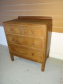 A small light oak Brynmawr Furniture chest of two long and two short drawers bearing Brynmawr label,