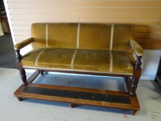 An Edwardian billiards room couch on raised foot-stand and mustard upholstery, 73 ins wide (186
