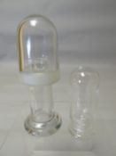 Two clear double covered re-agent bottles