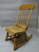 A small primitive New England style rocking-chair with spindle back