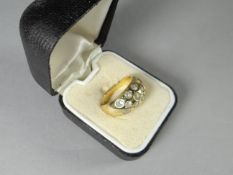 An 18ct yellow gold eleven diamond keeper ring, 5.4 gms