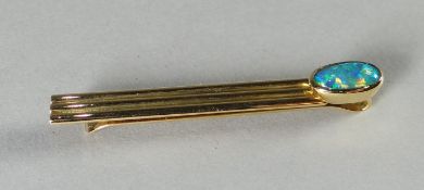 An Australian 18k gold (marked 750) and single oval opal tie-slide