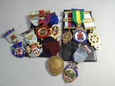 A parcel of enamel decorated Masonic medals on ribbons including a silver-gilt 'Neath Lodge' example
