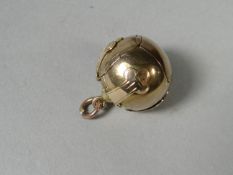 A yellow metal Masonic 'cross and ball' pendant charm