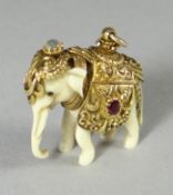 An Indian pendant in the form of an ivory domestic elephant with believed gold decorative saddle,