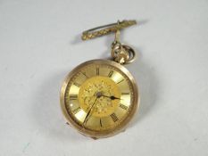 A finely chased 14k yellow gold ladies fob watch, the dial bearing Roman numerals and floral centre,