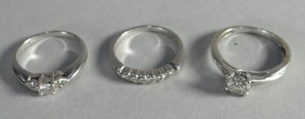 Two 18ct white gold rings with diamonds together with a 9ct similar, 7.3gms total